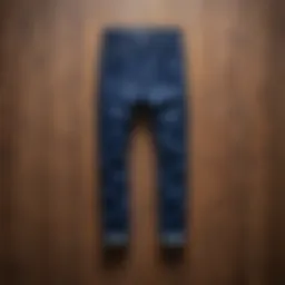 A stylish pair of indigo pants displayed on a wooden background